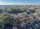 An aerial view showing the surrounding neighborhood, mature trees and a distant skyline at 2107 Seavey Dr, Decatur, GA 30032