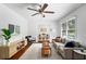 Bright living room featuring a ceiling fan, hardwood floors, neutral-colored furniture, and an open floor plan at 2107 Seavey Dr, Decatur, GA 30032