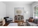 Comfortable seating area with a gray couch, decorative pillows, an accent chair, and gleaming hardwood floors at 2107 Seavey Dr, Decatur, GA 30032