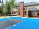 A backyard with a custom basketball court and brick home at 3553 Old Maple Dr, Johns Creek, GA 30022