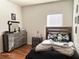 Bedroom featuring a gray dresser and wood laminate flooring at 3553 Old Maple Dr, Johns Creek, GA 30022