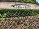 Madison Park entrance with stone signage surrounded by colorful flowers and greenery at 3553 Old Maple Dr, Johns Creek, GA 30022