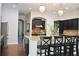 Kitchen island featuring granite countertops, dark cabinetry, and stainless steel appliances at 3553 Old Maple Dr, Johns Creek, GA 30022