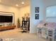 Bright playroom features a TV, built in storage, large window and play house at 3553 Old Maple Dr, Johns Creek, GA 30022