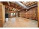 Unfinished basement with exposed beams, utilities, and walkout access, offering potential for customization at 810 Towergate Pl, Atlanta, GA 30350