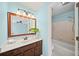 Well-lit bathroom with vanity, framed mirror and shower-tub combination at 810 Towergate Pl, Atlanta, GA 30350