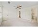 Carpeted bedroom featuring a ceiling fan, two closets and attached bathroom at 810 Towergate Pl, Atlanta, GA 30350