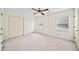 Spacious bedroom with plush carpeting, ceiling fan and ample natural light from two windows at 810 Towergate Pl, Atlanta, GA 30350