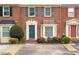 Charming brick townhome featuring colorful shutters and a well-manicured front garden at 810 Towergate Pl, Atlanta, GA 30350