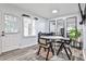 Bright dining area with modern table set, stylish decor, and natural light from the nearby window and door at 15 Pine Canyon Sw Dr, Atlanta, GA 30331