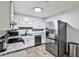 Bright kitchen featuring white cabinets, stainless steel appliances, and granite countertops at 15 Pine Canyon Sw Dr, Atlanta, GA 30331