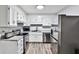 Modern, bright kitchen featuring new stainless steel appliances, granite countertops, and hardwood floors at 15 Pine Canyon Sw Dr, Atlanta, GA 30331