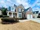 Charming brick and stone two-story home featuring a two-car garage and well-manicured lawn at 576 Lawton Bridge Sw Rd, Smyrna, GA 30082