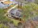 An aerial view showcasing the home's exterior, deck, driveway, and surrounding landscaping at 6664 Windwood Cir, Douglasville, GA 30135