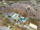 An aerial view showcasing neighborhood amenities, including swimming pools and a sand volleyball court at 6664 Windwood Cir, Douglasville, GA 30135