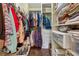 Organized walk-in closet featuring ample storage space, including shelves and hanging racks for clothes and accessories at 6664 Windwood Cir, Douglasville, GA 30135