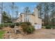 Two-story home with a stone chimney, an attached two-car garage and mature trees at 6664 Windwood Cir, Douglasville, GA 30135