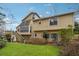 View of the home's deck, well-manicured lawn, and back exterior, with a sliding glass door at 6664 Windwood Cir, Douglasville, GA 30135