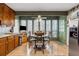 Bright eat-in kitchen features wood cabinetry, stainless appliances, and large sunroom dining area at 6664 Windwood Cir, Douglasville, GA 30135