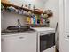Laundry room featuring front loading machines and shelving for storage at 6664 Windwood Cir, Douglasville, GA 30135
