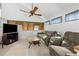 Cozy living room features comfortable seating, natural light, and ceiling fan for a comfortable gathering space at 6664 Windwood Cir, Douglasville, GA 30135