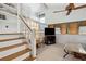 Inviting living room space with stairs, natural light, and a TV for entertainment at 6664 Windwood Cir, Douglasville, GA 30135