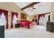 Primary bedroom features vaulted ceiling, ceiling fan and en-suite at 6664 Windwood Cir, Douglasville, GA 30135
