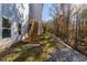 Wood stairs leading to a white two-story home with a treed lot at 2381 Highpoint Rd, Snellville, GA 30078