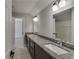 Bathroom features double vanity with granite countertop and modern lighting at 2381 Highpoint Rd, Snellville, GA 30078