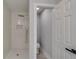 Modern all-white bathroom featuring a sleek walk-in shower and adjacent toilet at 2381 Highpoint Rd, Snellville, GA 30078