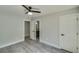 Bedroom features gray wood floors, two white doors, and a modern ceiling fan at 2381 Highpoint Rd, Snellville, GA 30078