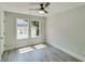 This bright bedroom features gray wood floors and plenty of natural light at 2381 Highpoint Rd, Snellville, GA 30078