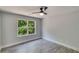 Bedroom features wood-look floors and a large window overlooking the lush green backyard at 2381 Highpoint Rd, Snellville, GA 30078