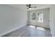 This bedroom features neutral walls, gray wood floors, and a modern ceiling fan at 2381 Highpoint Rd, Snellville, GA 30078