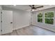 Bedroom featuring hardwood floors, a ceiling fan, and natural light from the windows at 2381 Highpoint Rd, Snellville, GA 30078