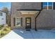 Entryway to a new brick construction duplex with covered front porch at 2381 Highpoint Rd, Snellville, GA 30078