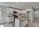 Well-lit kitchen featuring white cabinetry, stainless steel appliances, and a granite-topped island at 2381 Highpoint Rd, Snellville, GA 30078