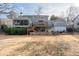 Large backyard showing a house with a deck, screened porch and stone patio at 343 Woodstone Dr, Marietta, GA 30068