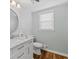 Bright bathroom with a white vanity, round mirror, and updated fixtures at 343 Woodstone Dr, Marietta, GA 30068