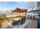 Outdoor deck featuring a dining table with seating and an umbrella at 343 Woodstone Dr, Marietta, GA 30068