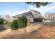 Exterior view showing the home's attached two car garage and landscaped front yard at 343 Woodstone Dr, Marietta, GA 30068