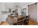 Modern kitchen with stainless steel appliances, white cabinets, island and a rustic sliding barn door at 343 Woodstone Dr, Marietta, GA 30068