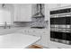 Modern kitchen with quartz countertops, stainless steel appliances, and mosaic backsplash at 343 Woodstone Dr, Marietta, GA 30068