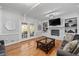 Cozy living room with a white brick fireplace, built-in shelves, and hardwood floors at 343 Woodstone Dr, Marietta, GA 30068