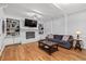 Comfortable living room with a decorative fireplace, built-in shelves, and hardwood floors at 343 Woodstone Dr, Marietta, GA 30068