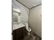 Bathroom with marbled walls, wood-look flooring, and a wooden vanity at 463 Kingston Court, Hampton, GA 30228