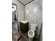 Bathroom with marbled walls, wood-look flooring, and a wooden vanity at 463 Kingston Court, Hampton, GA 30228