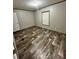 Bedroom with wood-look flooring and a window providing natural light at 463 Kingston Court, Hampton, GA 30228