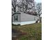 Beautiful home featuring gray vinyl siding, black shutters, and well manicured lawn at 463 Kingston Court, Hampton, GA 30228