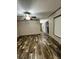 Living room with wood-look flooring, ceiling fan, and natural light from window at 463 Kingston Court, Hampton, GA 30228